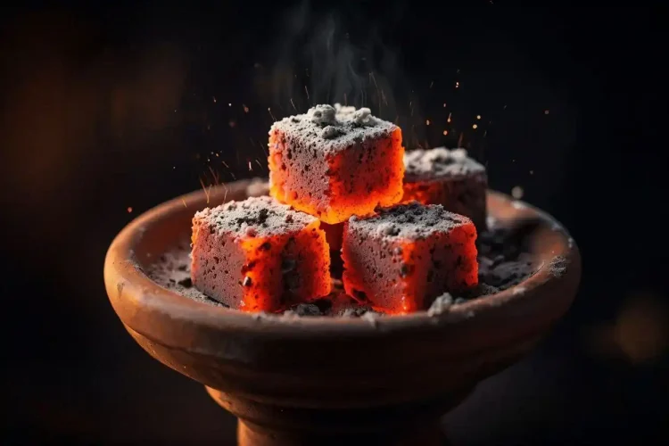 High heat shisha charcoal cubes glowing orange on a hookah bowl